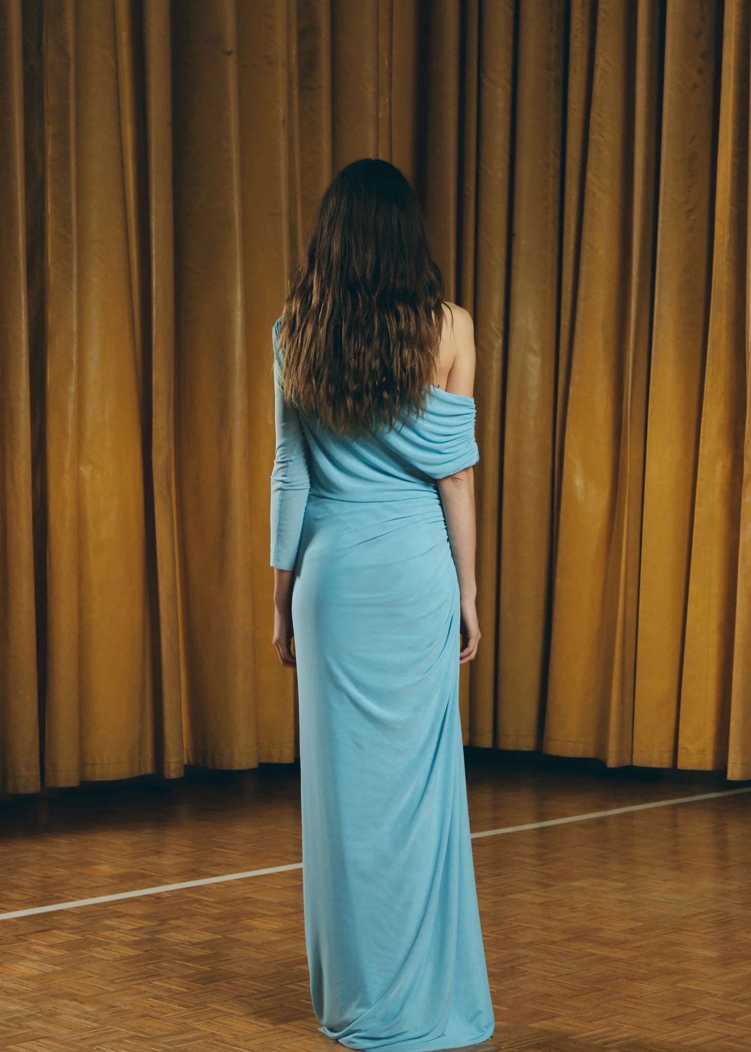 Blue Teresa Helbig draped gown for black tie wedding guest dressing