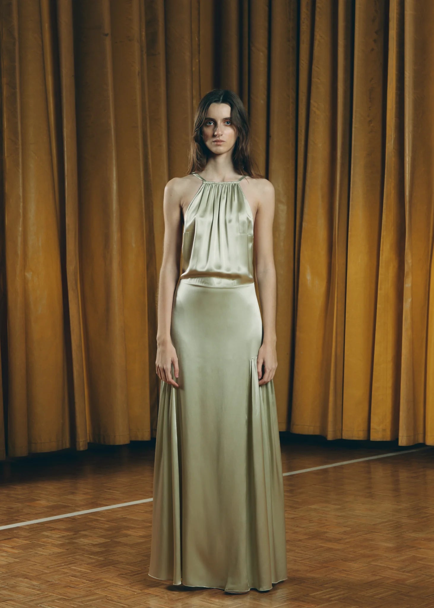 Sage green Teresa Helbig dress for modern wedding guest dressing